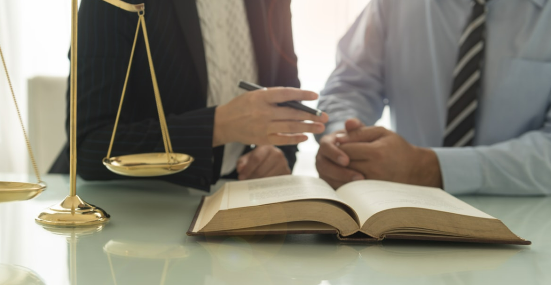 Group of professionals discussing professional liability insurance options in an office, showcasing a trusted insurance agency in Dayton, Ohio